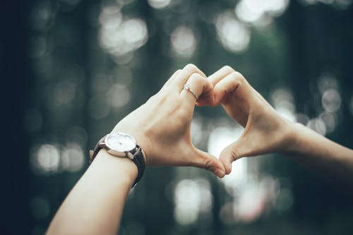 Free Close-Up Photography of Person Doing Heart Using Her Hands Stock Photo