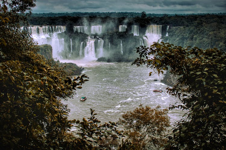 Photo Of The Iguazú Waterfall, A Lake And Boats In Brazil And Argentina