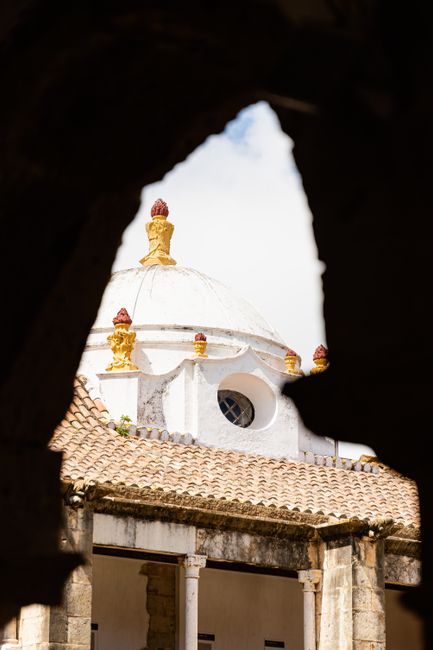 A stunning view of a historic dome framed by ancient walls in Faro, Portugal. Ideal for travel enthusiasts.