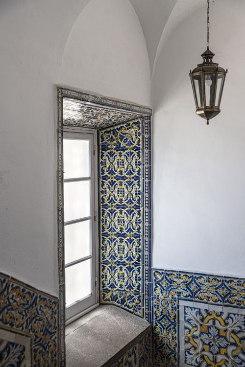 Free Detailed view of an ornate tiled wall and window in Faro, Portugal, showcasing intricate patterns and textures. Stock Photo