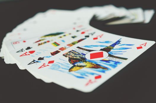 A visually striking close-up of a spread of playing cards showcasing colorful designs and aces.