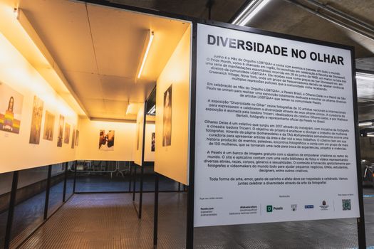 Photo exhibit showcasing LGBTQ+ diversity with impactful portraits in a museum setting.