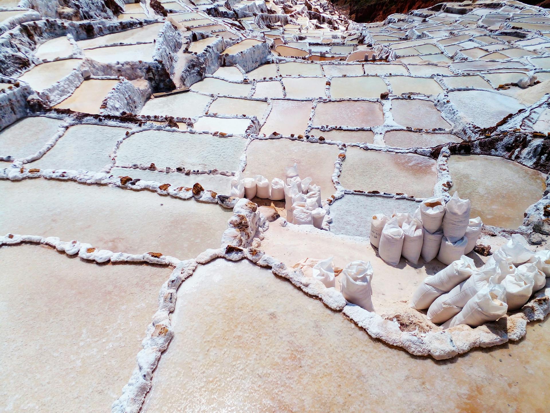 A stunning aerial view of Maras salt mines in Cusco, Peru, showcasing intricate salt evaporation ponds.