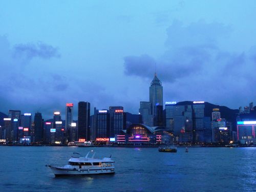 Free Stunning view of Hong Kong skyline with illuminated skyscrapers and Victoria Harbour at dusk. Stock Photo