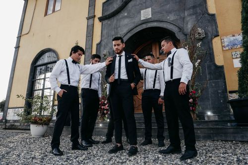 Free Groom with groomsmen in stylish suits preparing for wedding outdoors in Ecuador. Stock Photo