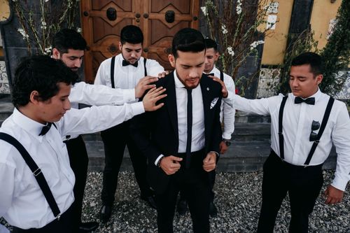 Free A group of elegantly dressed groomsmen supporting the groom outdoors in Ecuador. Stock Photo