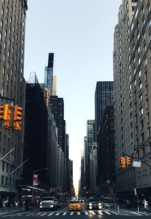 Free Bustling New York City street with skyscrapers and yellow taxi in daylight. Stock Photo