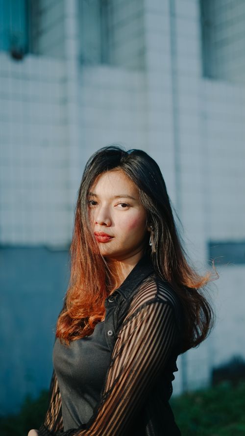 Free Vibrant outdoor portrait of a young woman in Indonesia with red lipstick and natural beauty. Stock Photo