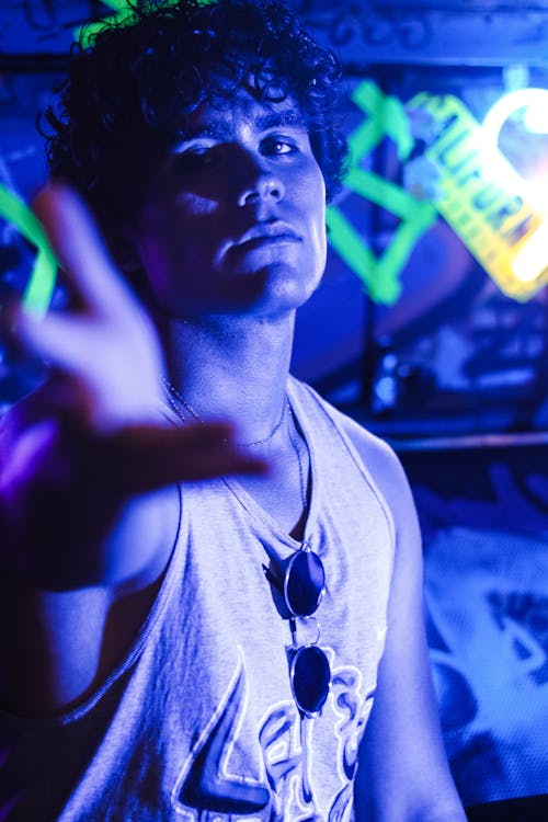 A Man in Tank Top with Blue Light 