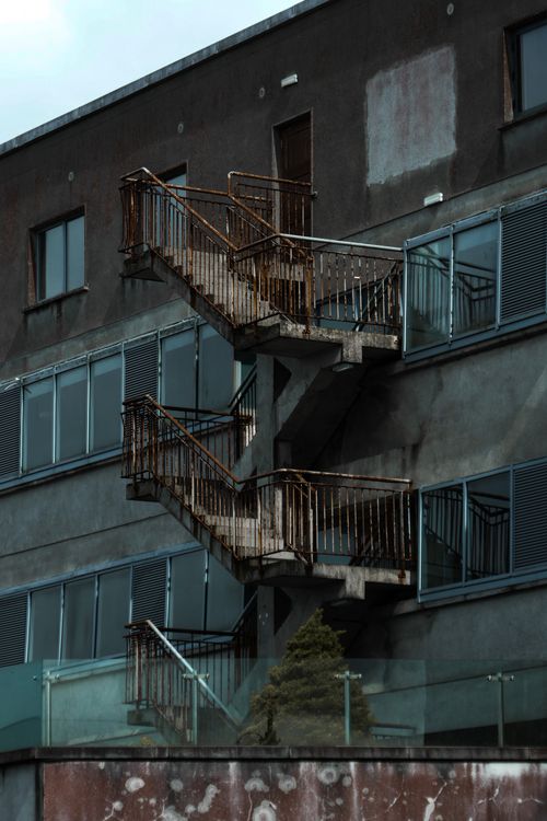 Free Multi-story building showcasing an industrial metal fire escape. Stock Photo