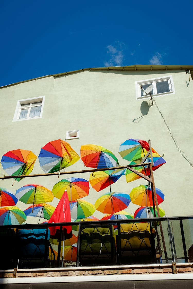 Photo Of A Balcony With A Coloured Umbrellas And Chairs