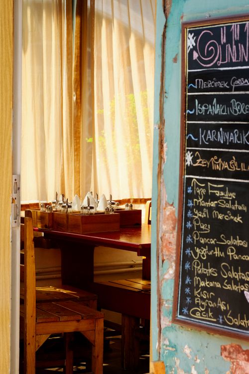 A cozy Brooklyn diner with a handwritten menu and a chef flipping a burger