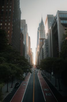 New York City street leading to the Chrysler Building, showcasing urban life and architecture.