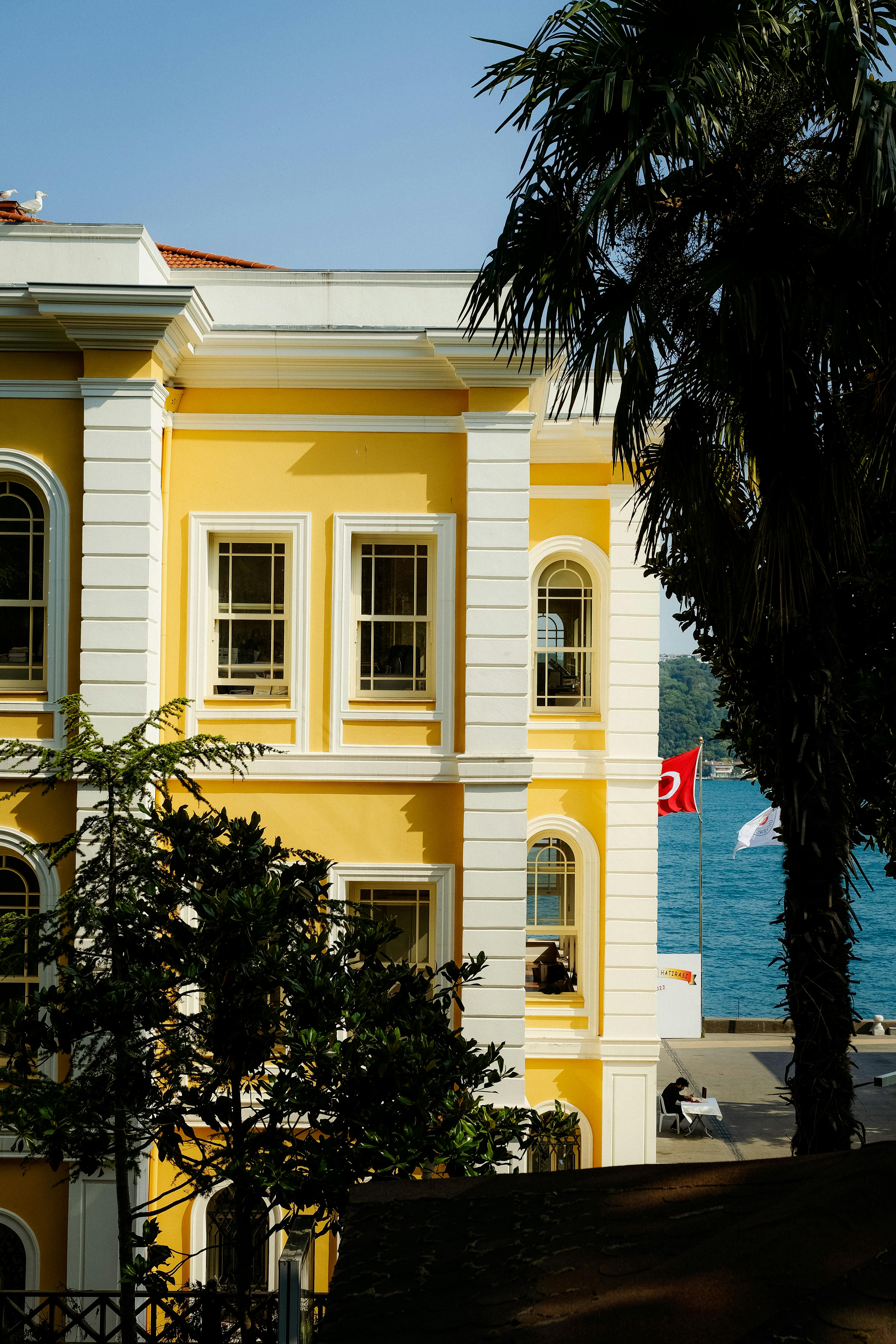 facade of bright yellow building on sea shore