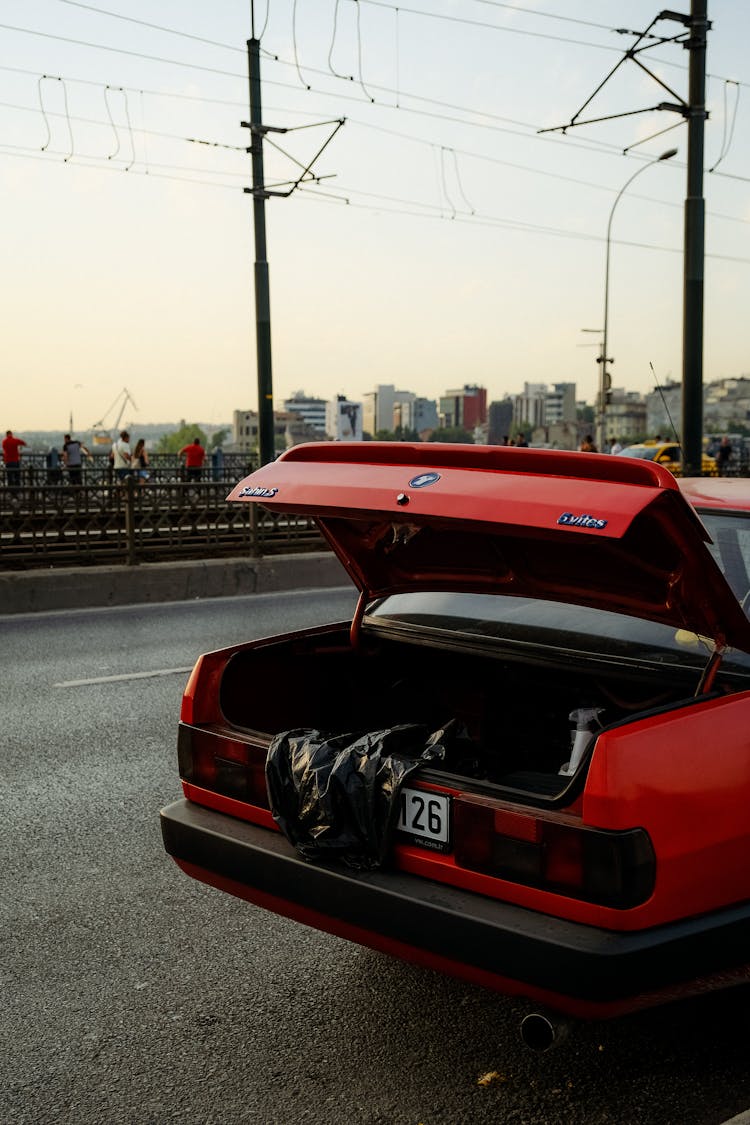 Old Car With Open Trunk On Road