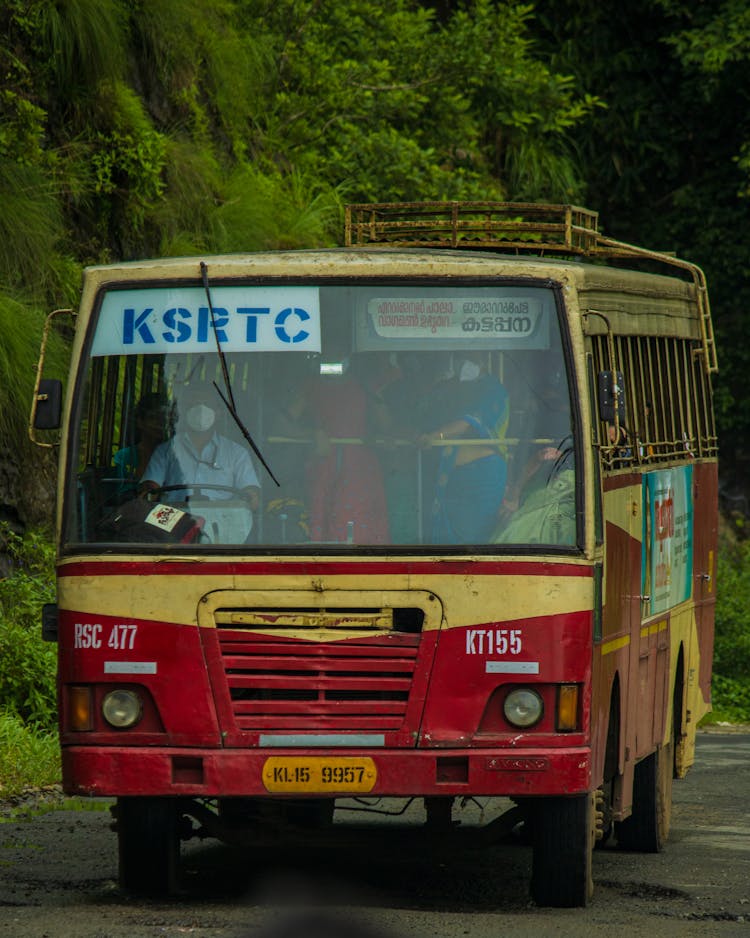 An Old Yellow And Red Bus On The Road