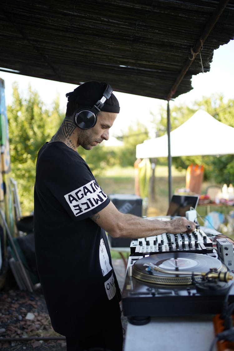 Side View Of A Man In Black Shirt Wearing Headphones