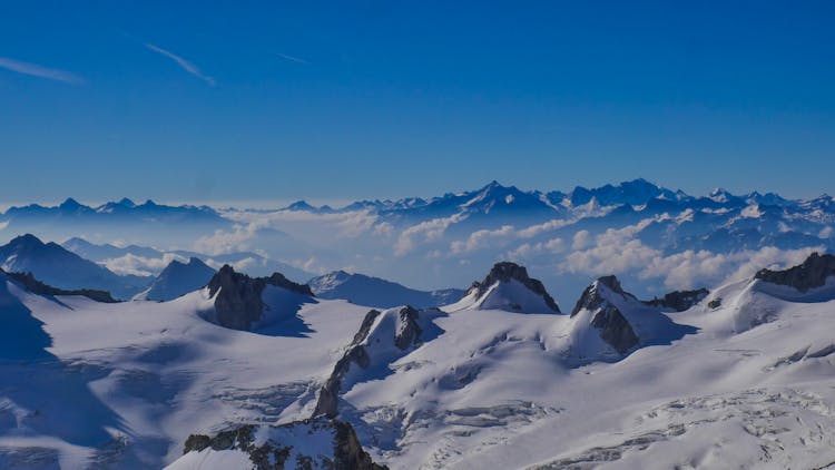 Photo Of The Mountain Peaks Covered In Show In The Alps 