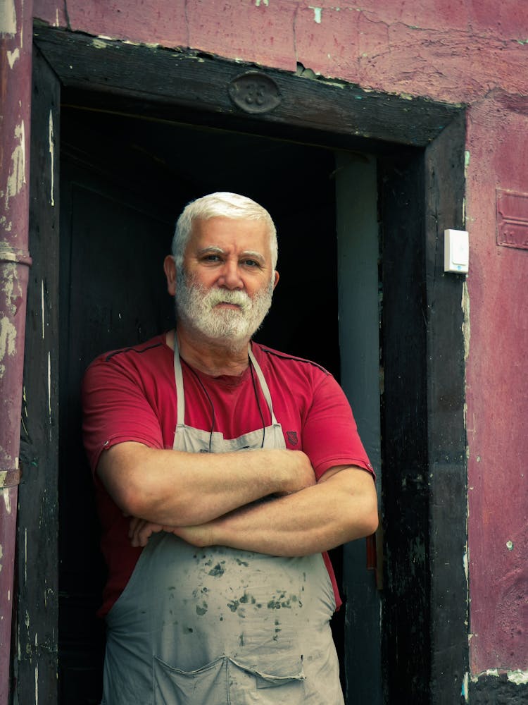 An Elderly Man In Gray Apron