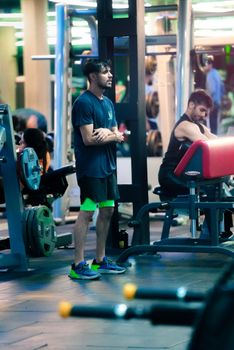 Men engaged in workout routines at a modern indoor gym in Chandigarh, India.