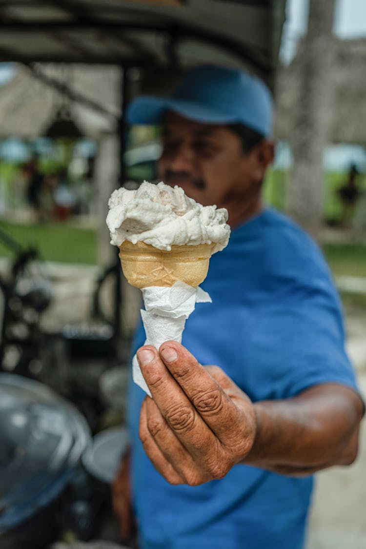 A Man Holding Vanilla Ice Cream On Cone