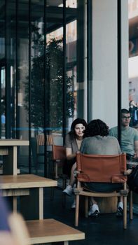 People enjoying a relaxed atmosphere in a modern Istanbul café with wooden furniture.