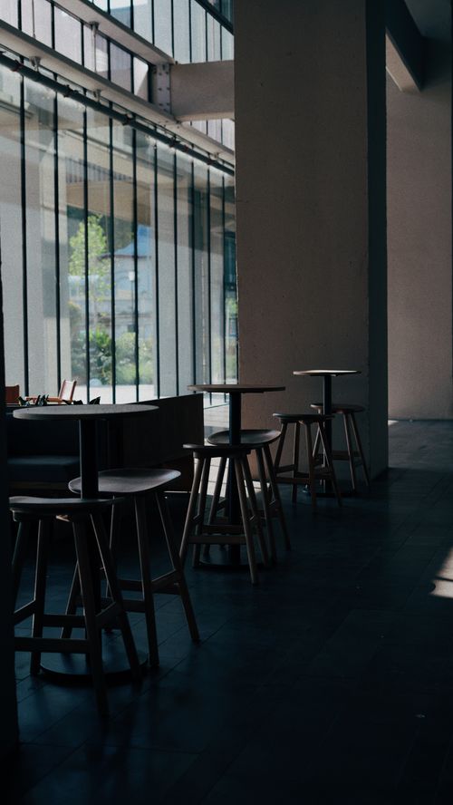 Free Elegant minimalist cafe interior in Istanbul, Turkey, featuring wooden furniture and natural light. Stock Photo