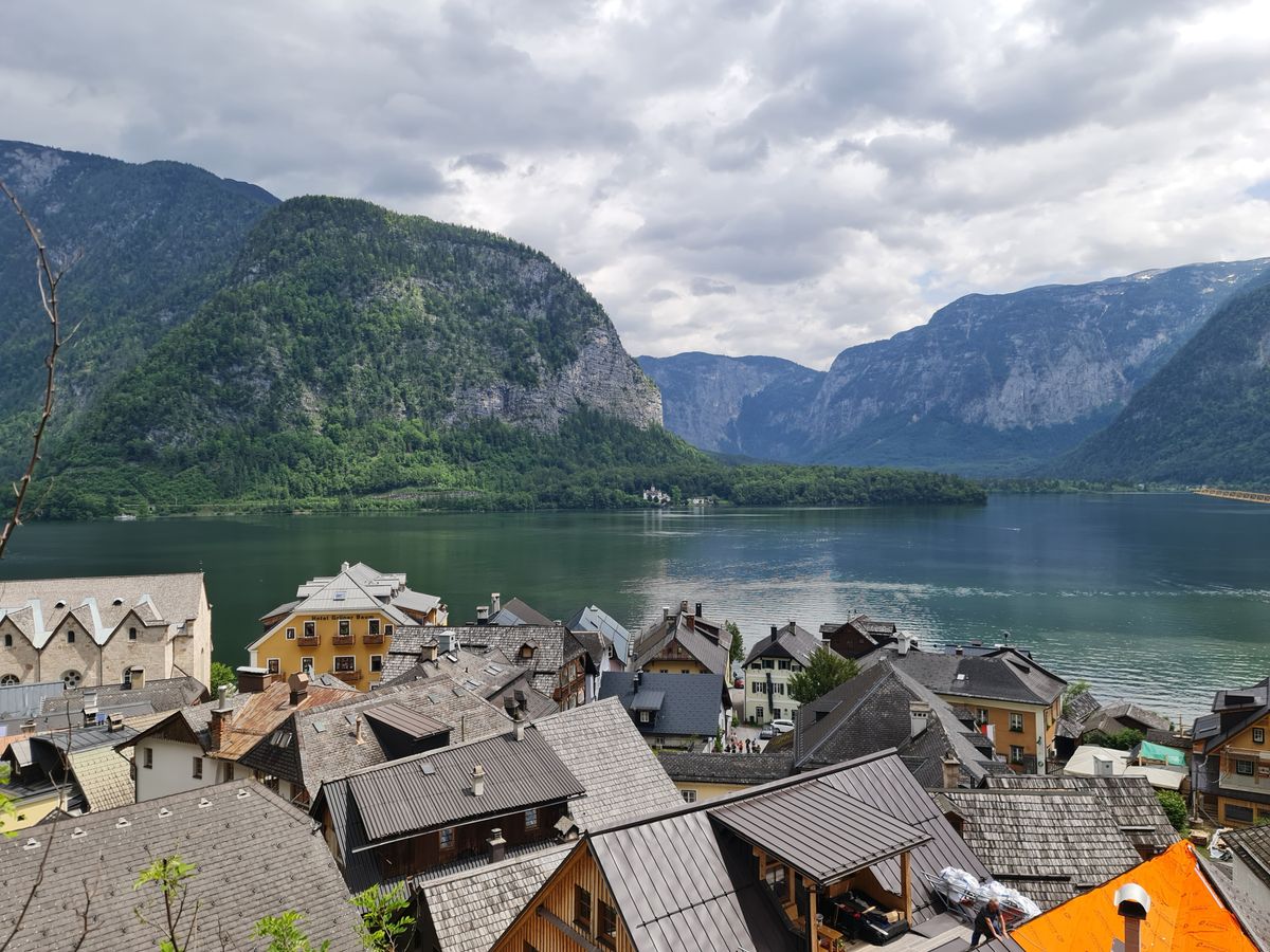 Aerial view of Hallstatt's charming rooftops, tranquil lake, and surrounding mountains in Austria.