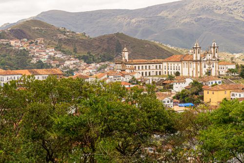 Free A picturesque view of Ouro Preto, Brazil, featuring historic colonial buildings nestled in the hills. Stock Photo