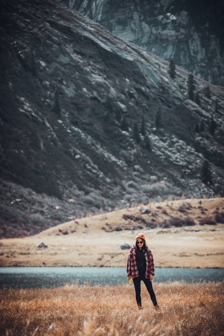 Woman Hikding With Mountains And River In The Distance 