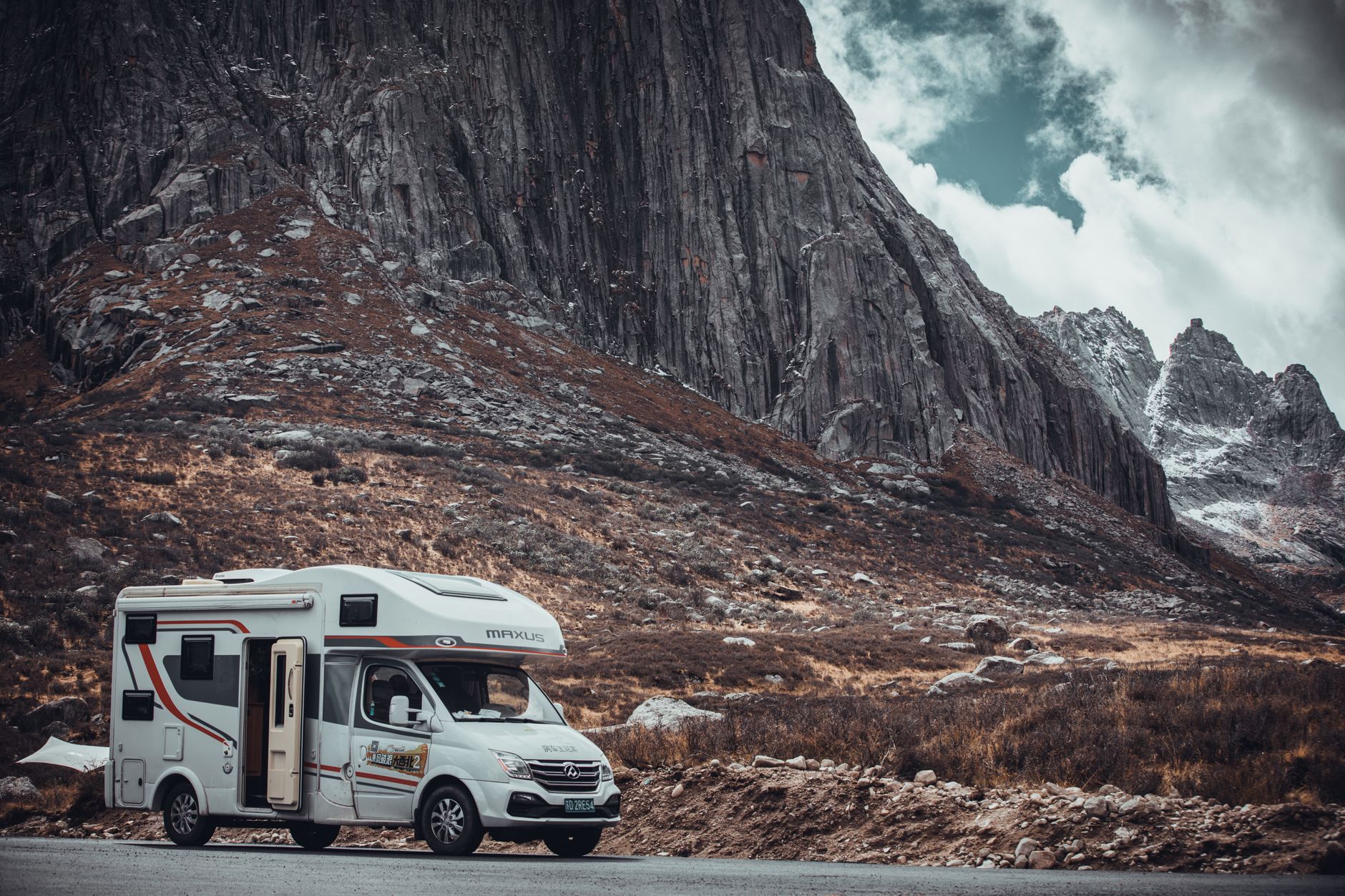 Experience travel freedom in a campervan with stunning mountain landscapes and rugged terrain.