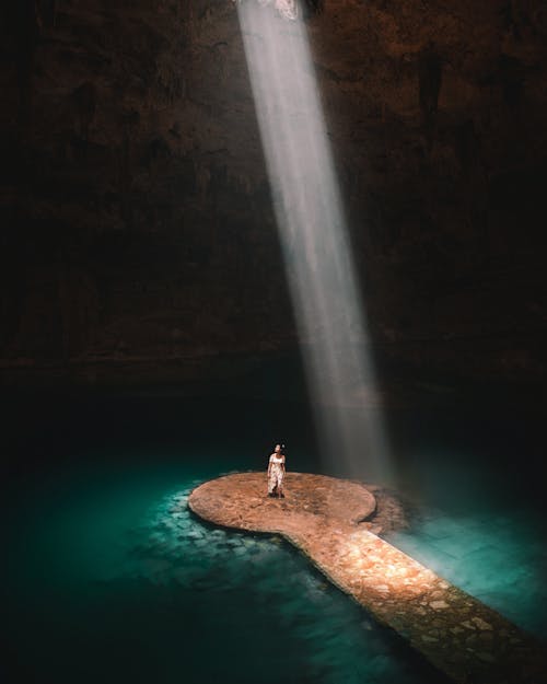 Free Woman Standing Inside the Cenote Suytun in Mexico  Stock Photo
