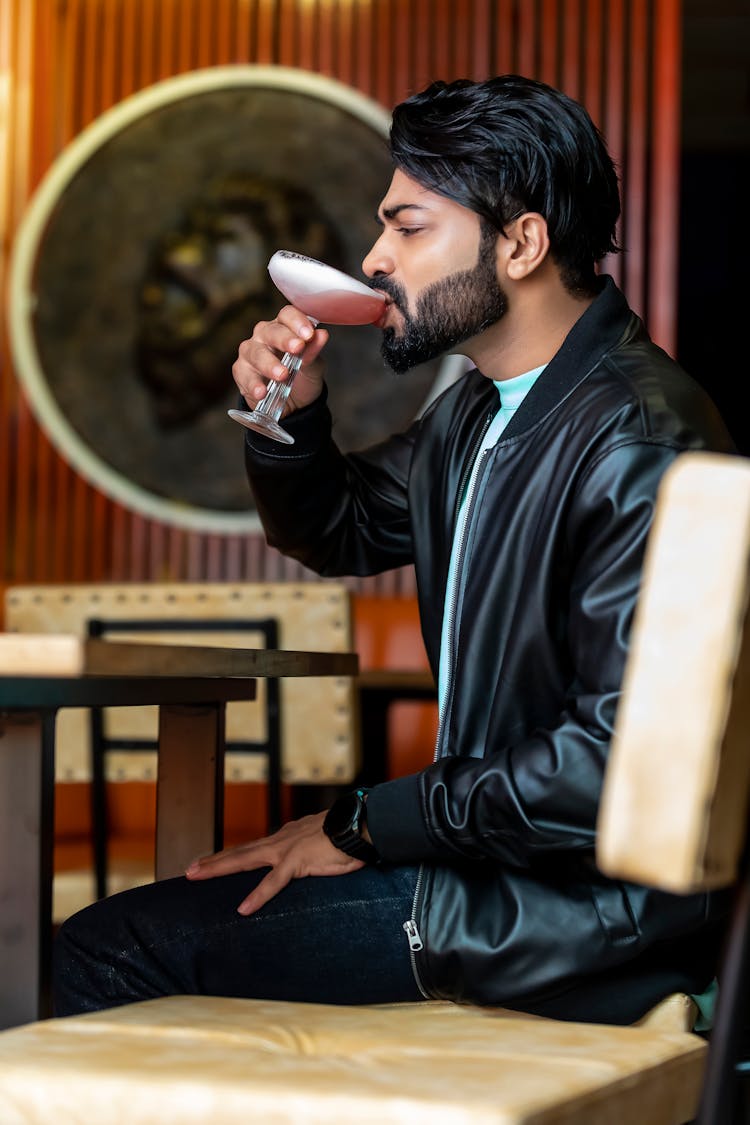 Man Drinking A Cocktail In A Bar