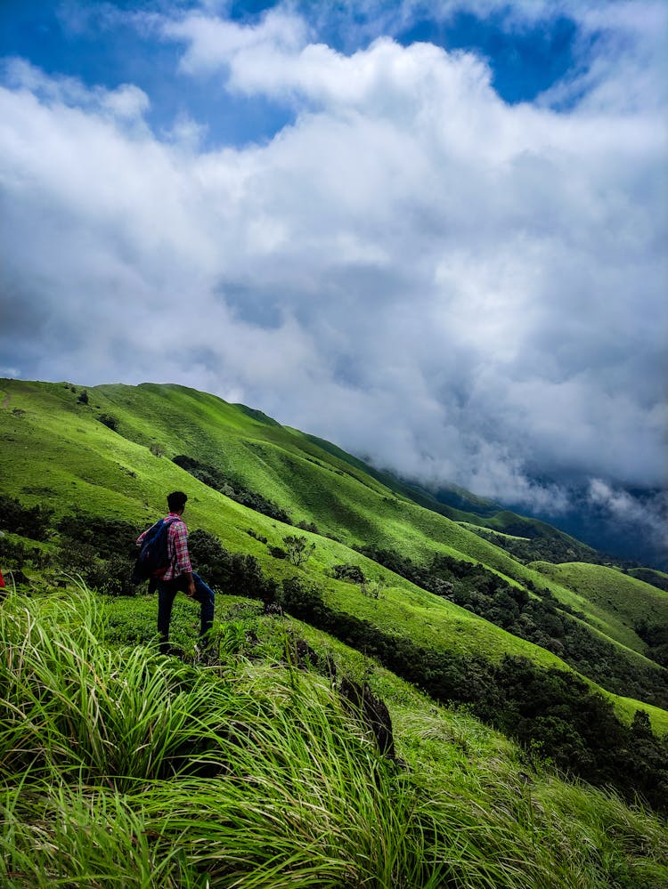 A Man Hiking A Mountain