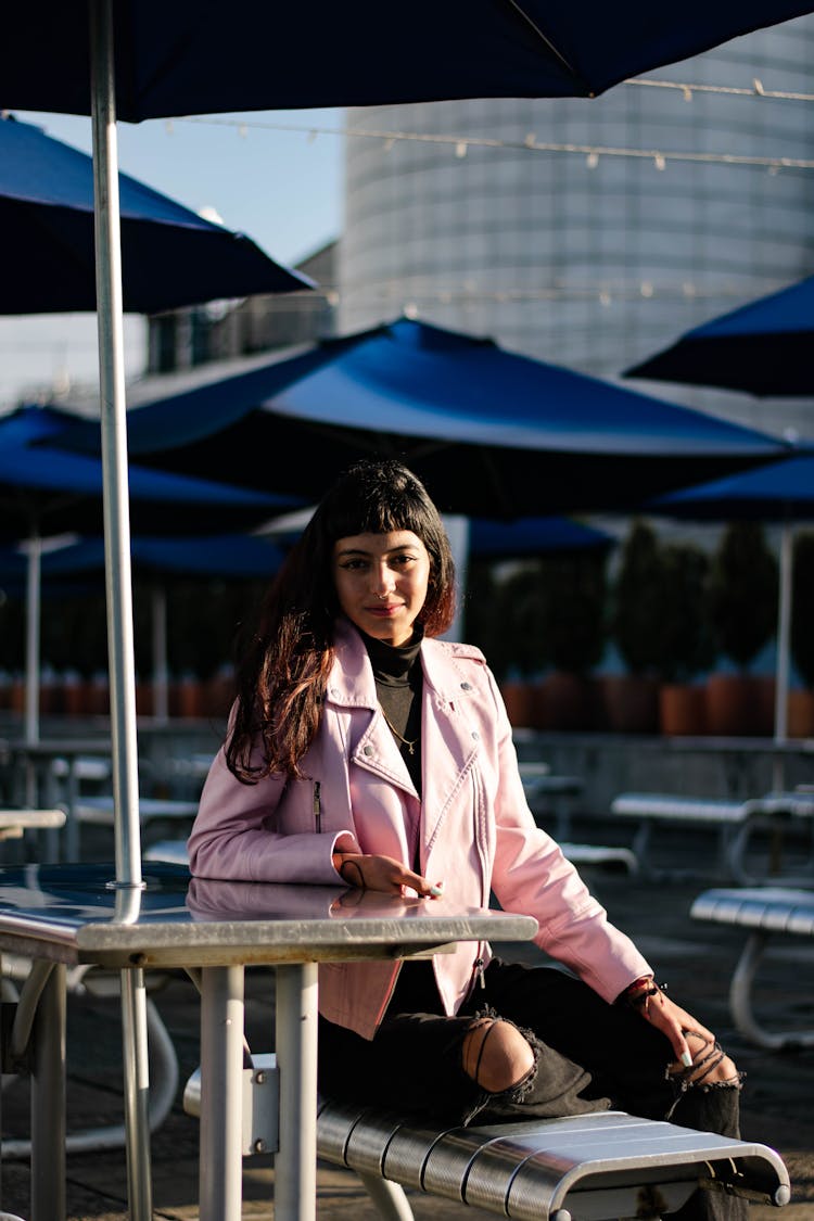 Woman Sitting At Table At Outdoor Restaurant Terrace