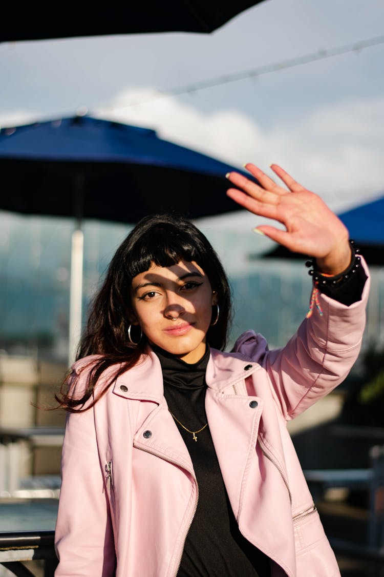 Young Woman Blocking The Sun With Her Hand 