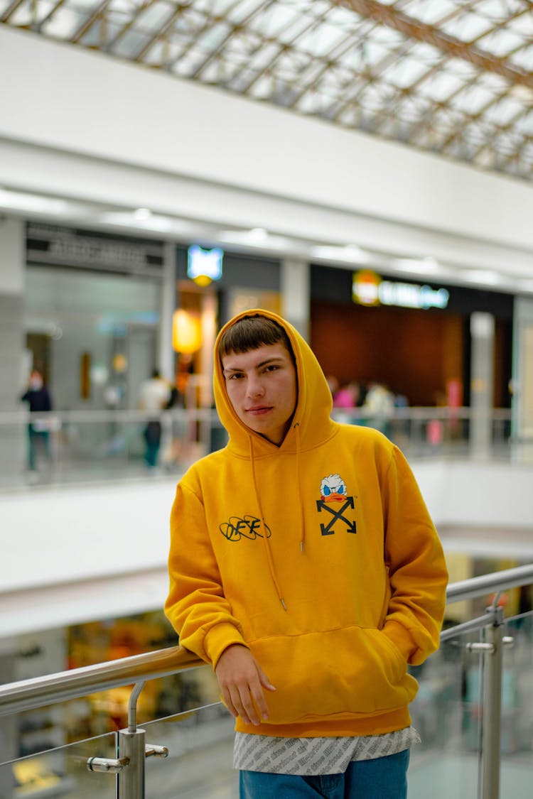 Man In Yellow Hoodie Sweater Inside A Mall