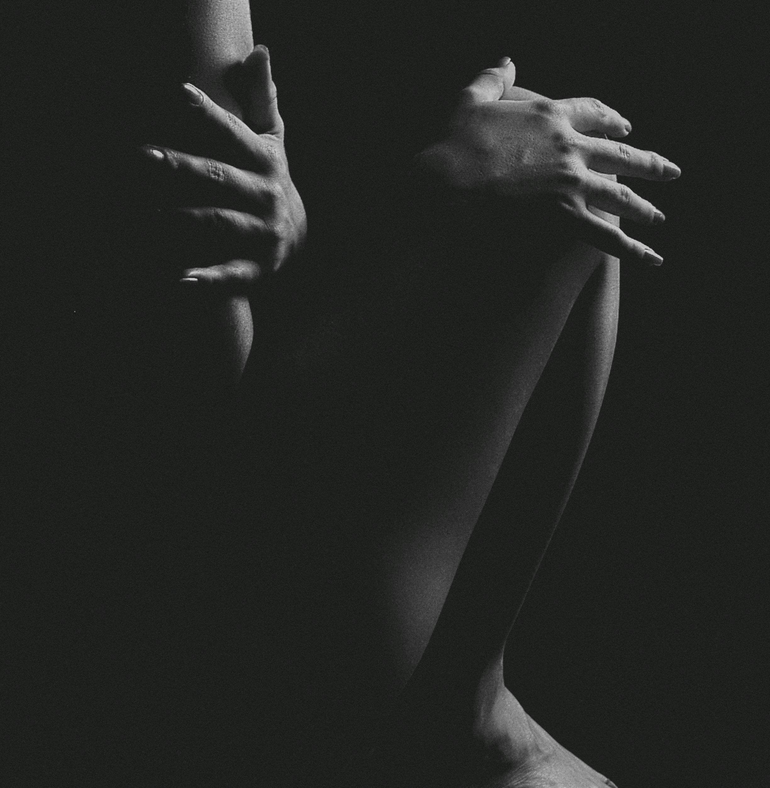 grayscale photo of naked woman in a dark room