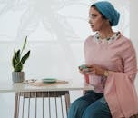 Woman Sitting on Chair Near a Table