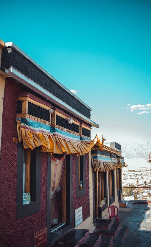 Free Close-up of colorful Tibetan building with mountain backdrop. Stock Photo