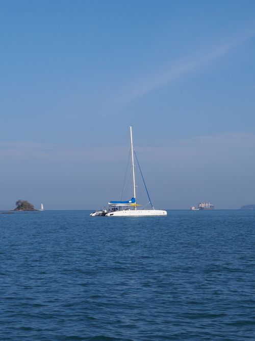 Free A sleek sailboat glides across a calm blue sea on a sunny day, capturing a serene nautical scene. Stock Photo