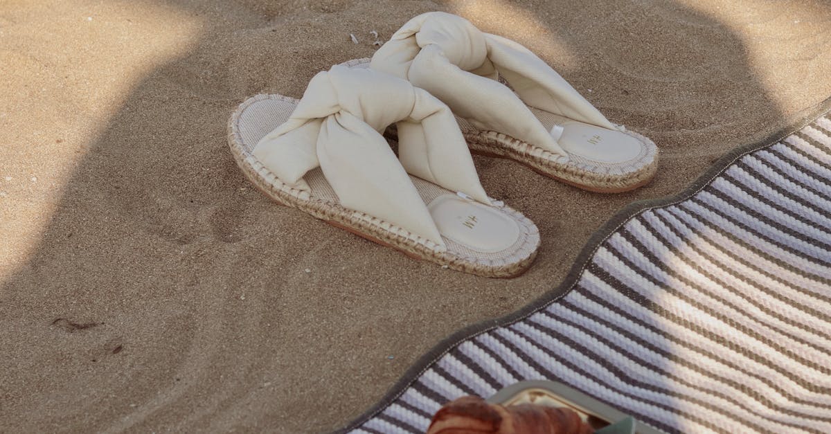 Sandals, Croissants and Coffee on a Towel on a Beach