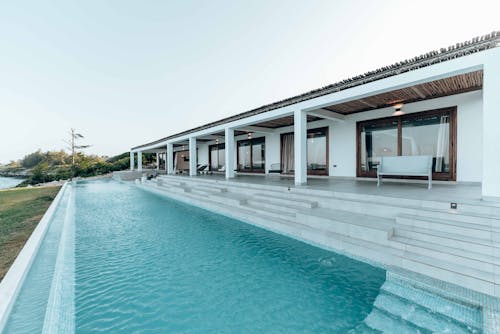 White and Gray Concrete Building Near Swimming Pool