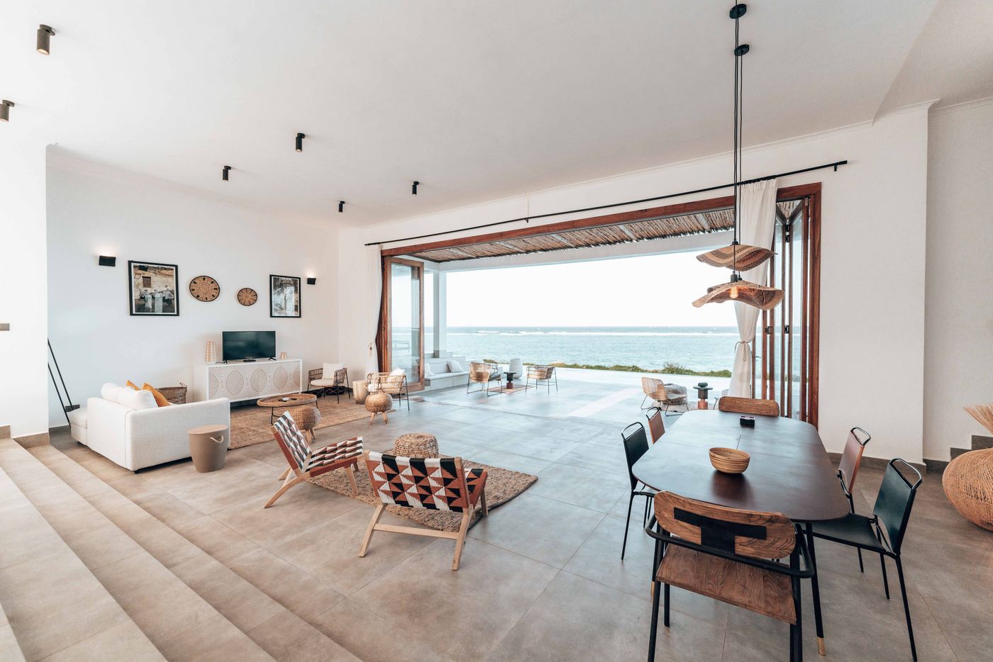 Great room with pocket doors fully open to the terrace and the ocean