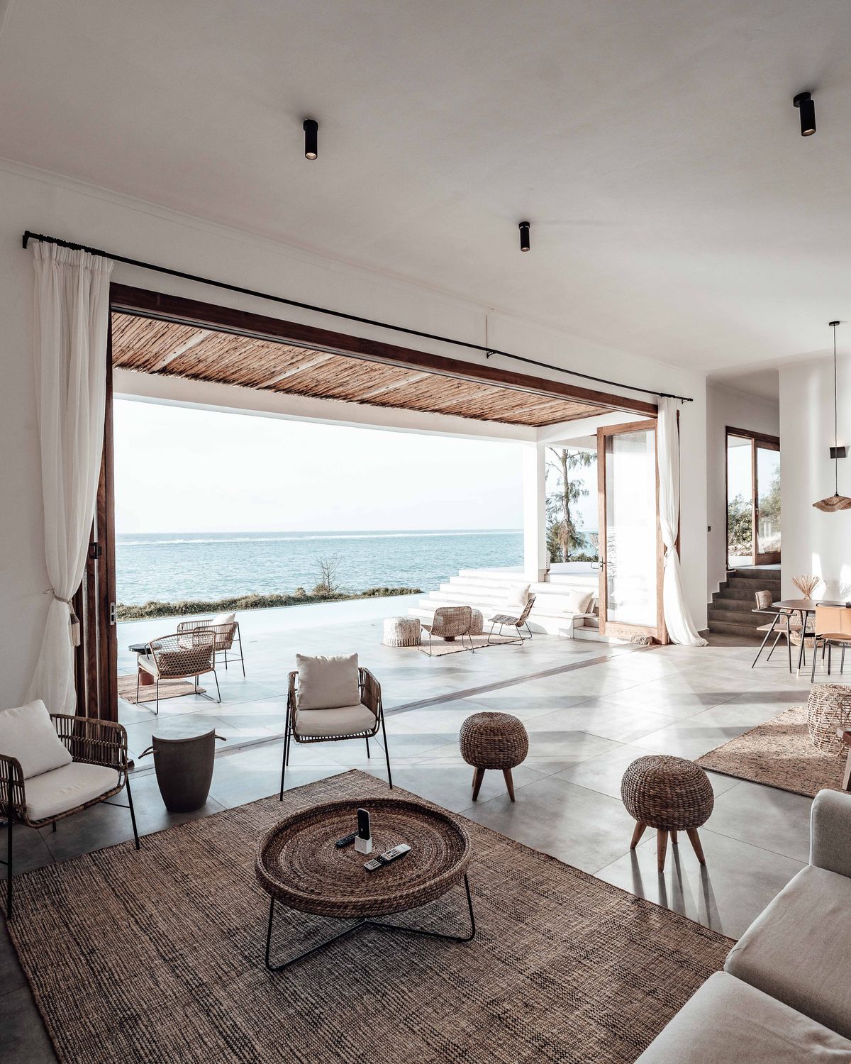 A bright, calm coastal living space looking out toward the water