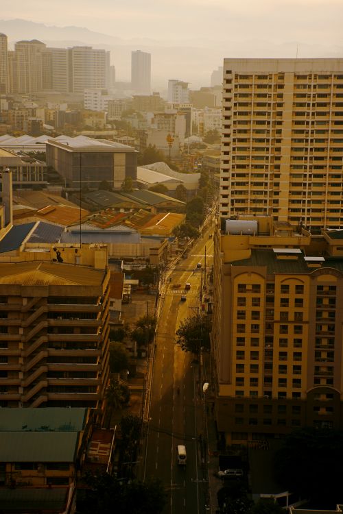 Free High-angle view of city buildings and streets during sunset with warm tones. Stock Photo
