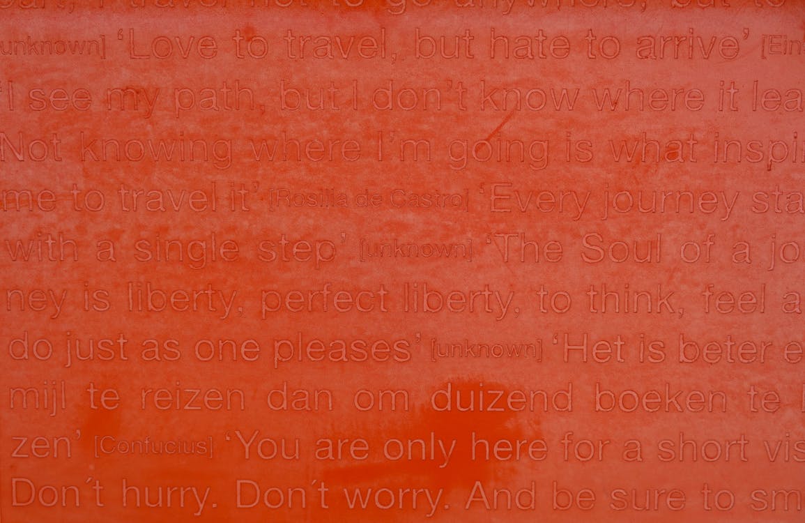 Close-up of a Red Surface with Engraved Quotes of Rosalia de Castro