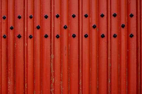 Close-up of an Old Red Wall with Black Dots 