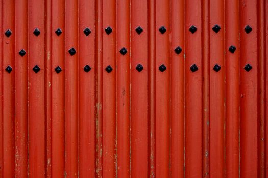 Red Metal Fence With White Round Holes