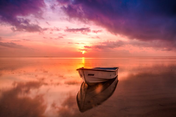 White Row Boat On Body Of Water